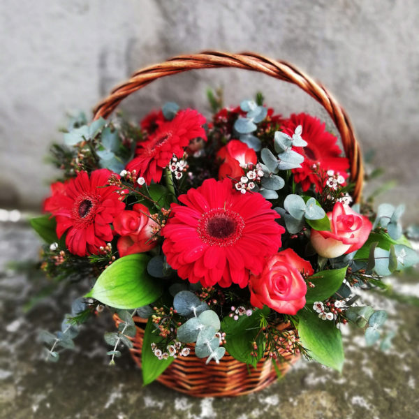 Basket with red gerberas and roses